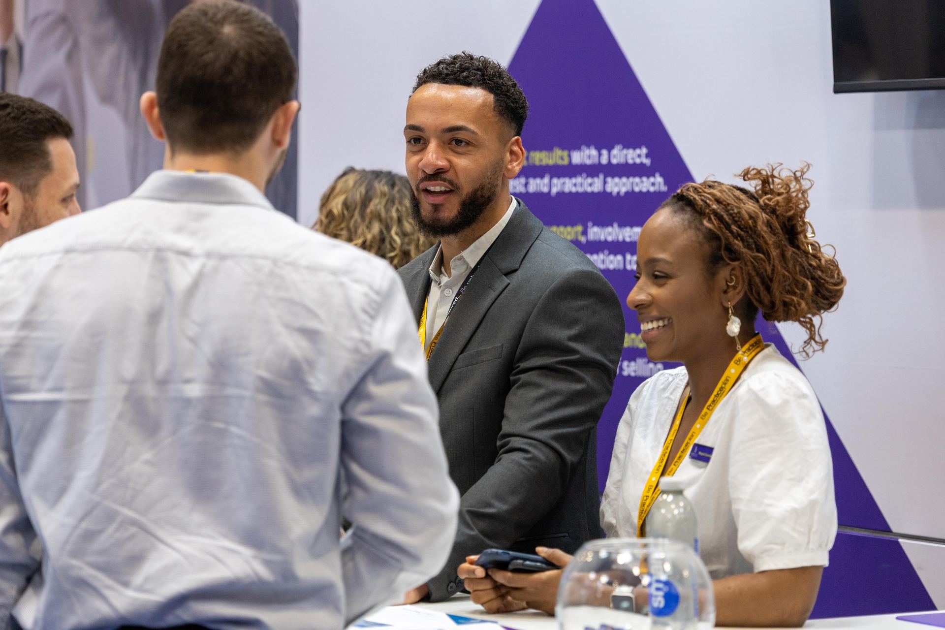 Delegates talking at an exhibition stand