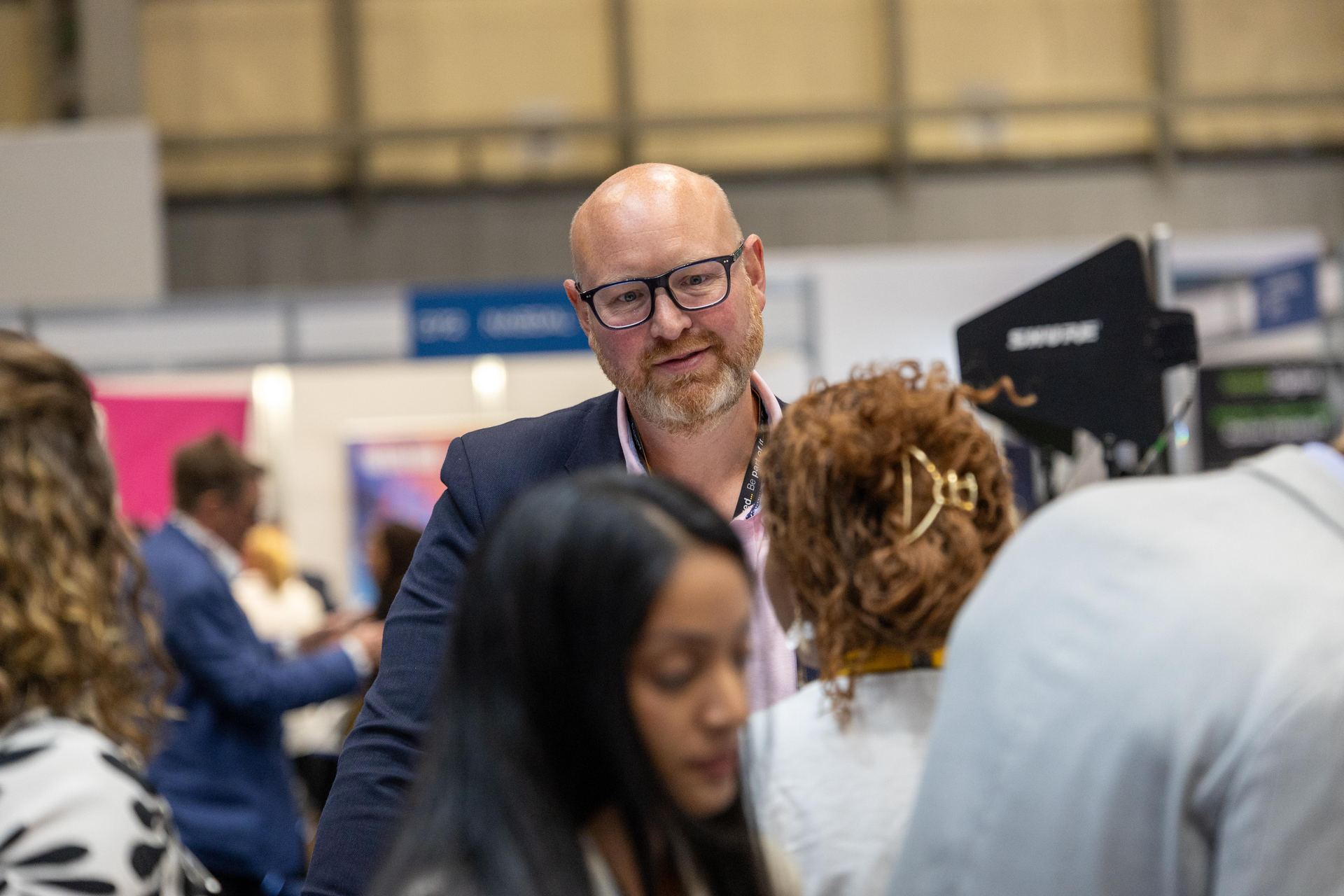 Attendee in conversation on the conference floor