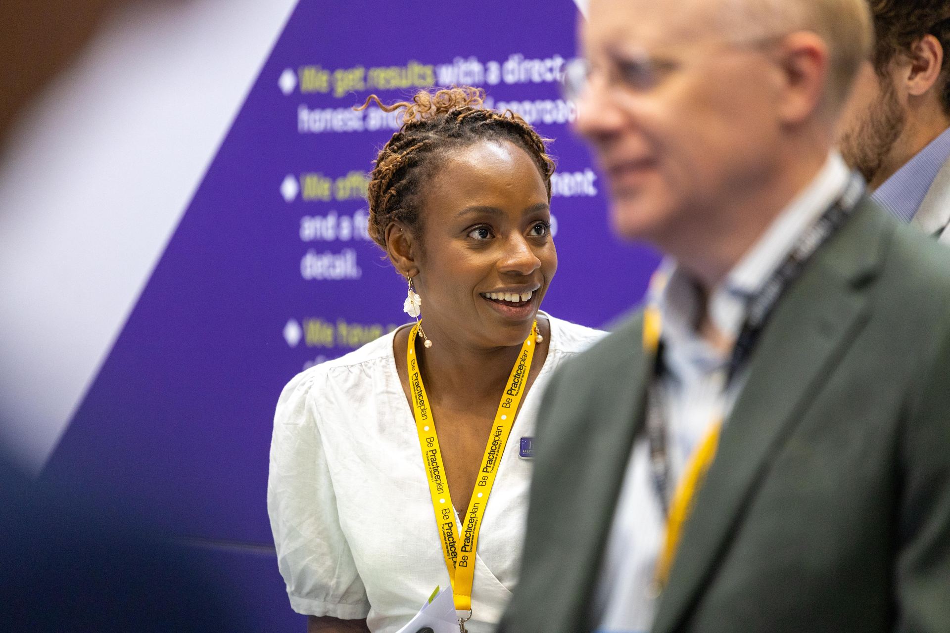Delegate smiling during a conversation at an exhibition stand