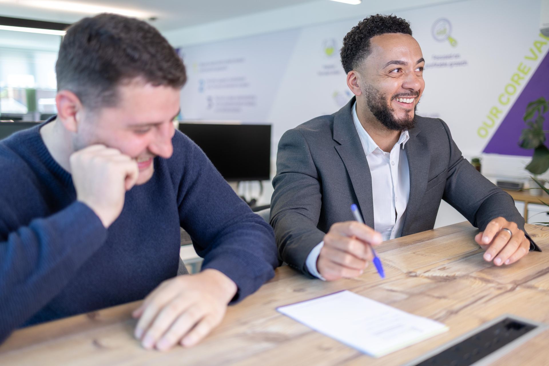 Two colleagues reviewing a document together in the office